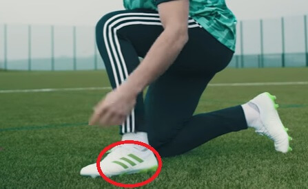 A soccer player showing his outside part of the foot