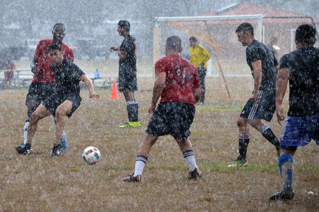Soccer Players playing in the rain