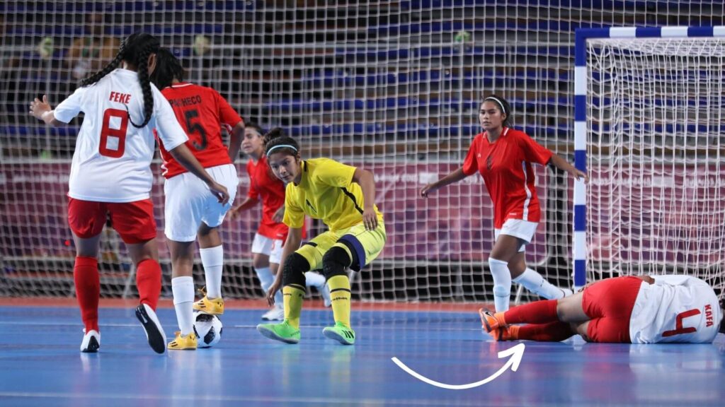 Do soccer players fake injuries - Soccer/football player injured on a futsal pitch