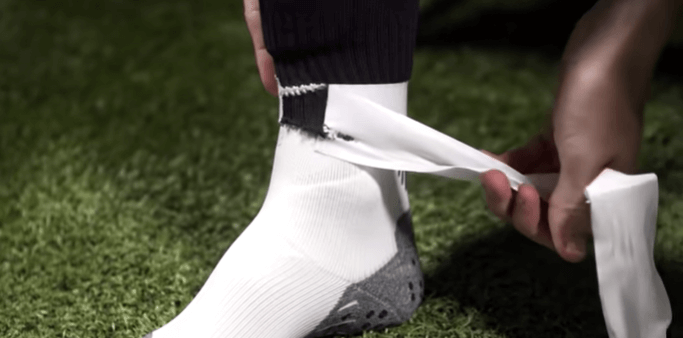 why do soccer players cut their socks - removing the tape from the sock