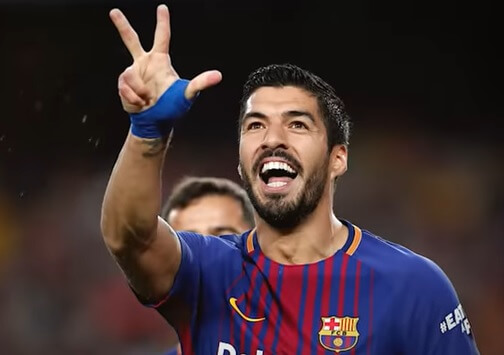why do soccer players wear wrist tape - luis suarez raising three fingers in the air
