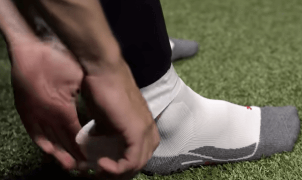 why do soccer players cut their socks - someone taping his socks