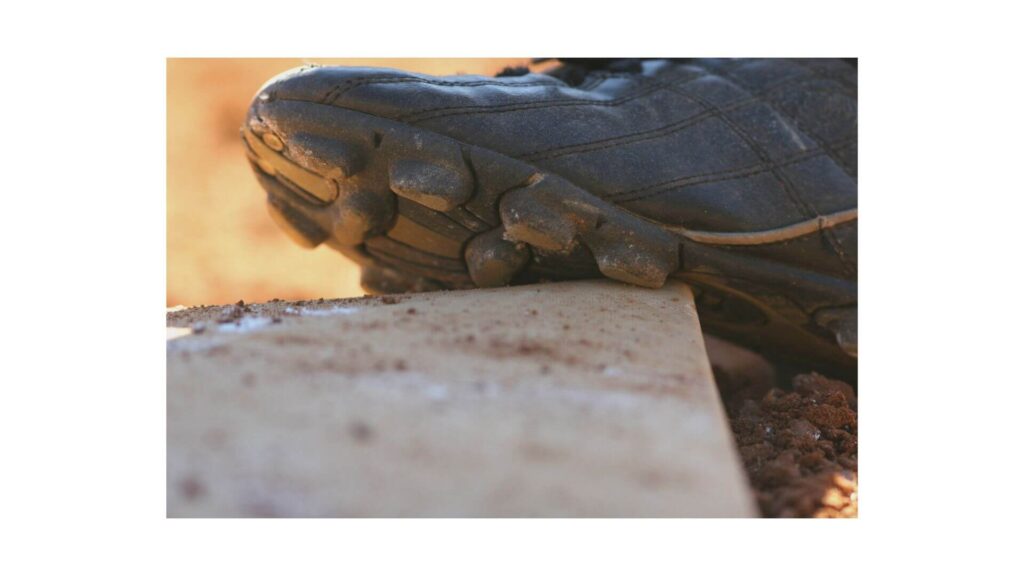 Baseball cleats vs Soccer cleats - baseball cleat on a stone