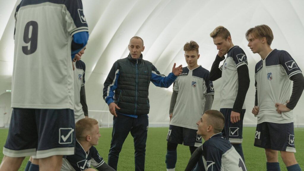 What is resilience in soccer - A coach giving instructions to players