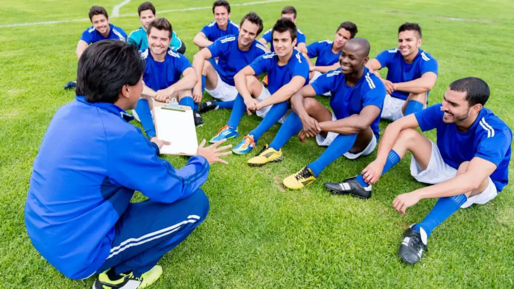 Pressure in soccer - Coach talking to soccer players sitting