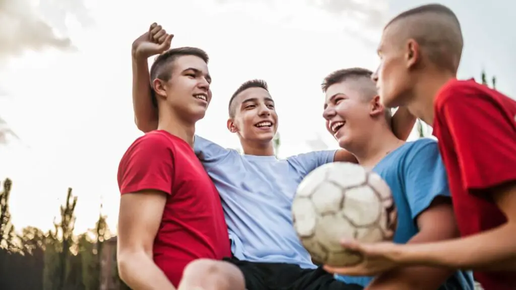What is resilience in soccer - Four soccer players happy