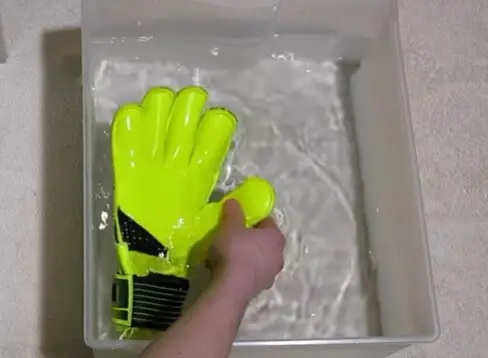 how to wash goalkeeper gloves - a pair of goalkeeper glove in cold water