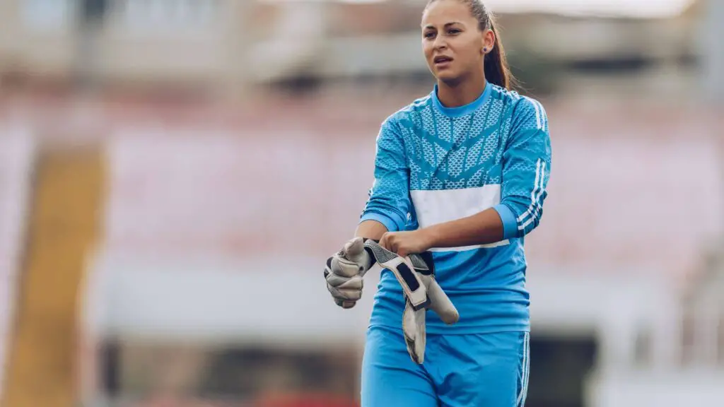 Do professional goalkeepers get new gloves every game - Woman goalkeeper wearing goalie gloves