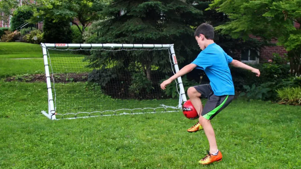 What is a Rebounder goal - A young soccer player training with a Rebounder goal