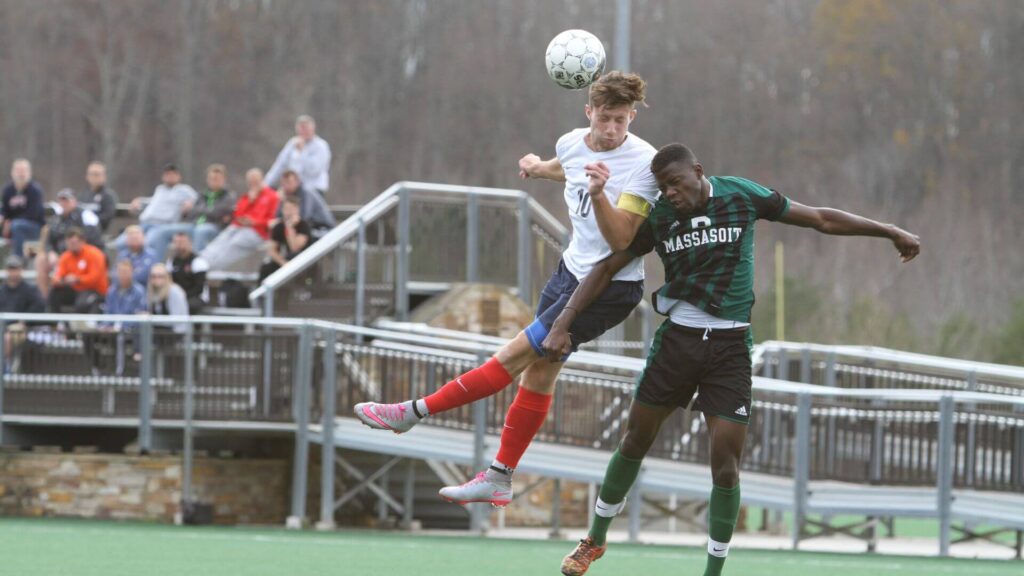 Do soccer players wear mouth guards - Two players jumping to header the ball