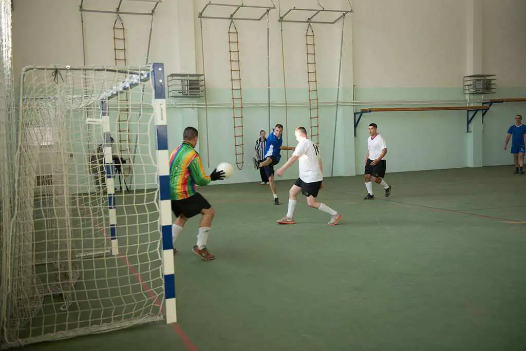 When was Futsal invented - Futsal player shooting in goal