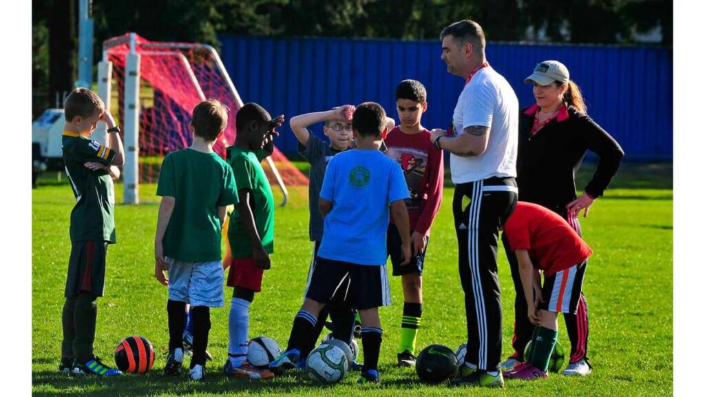 Sportsmanship in soccer - Coach talking to youth players