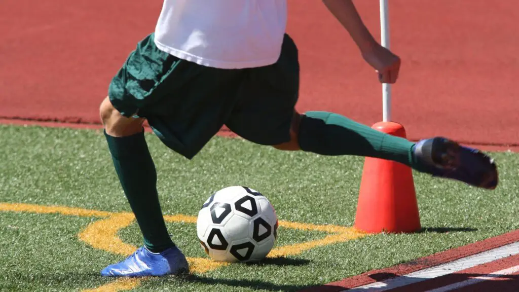 Soccer corner kick rules - A player taking a corner kick
