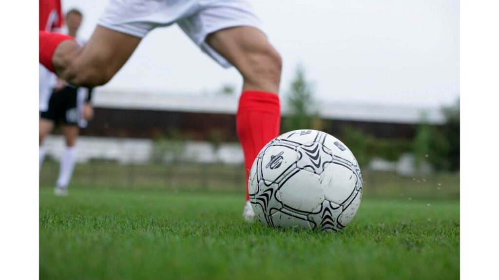 Shooting the ball in soccer - Player standing and about to hit the ball