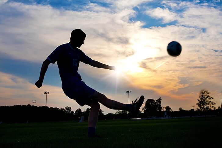 How to improve your weak foot in soccer - player shooting the ball